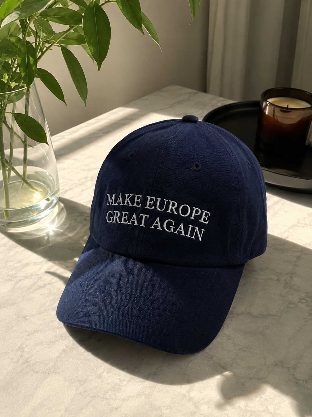 Navy Make Europe Great Again cap photographed by a customer on a marble table