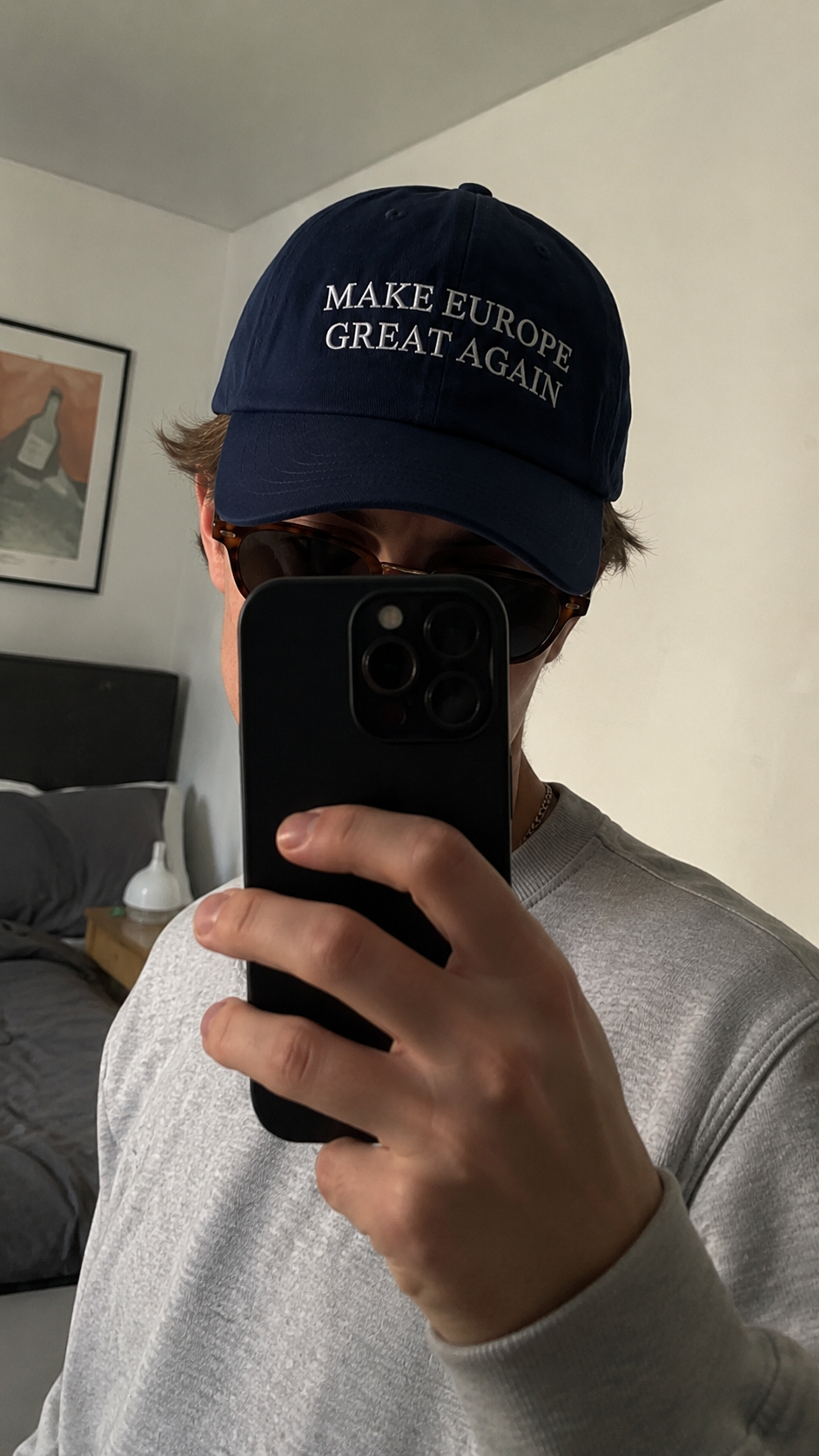 Customer mirror selfie wearing the navy Make Europe Great Again cap indoors